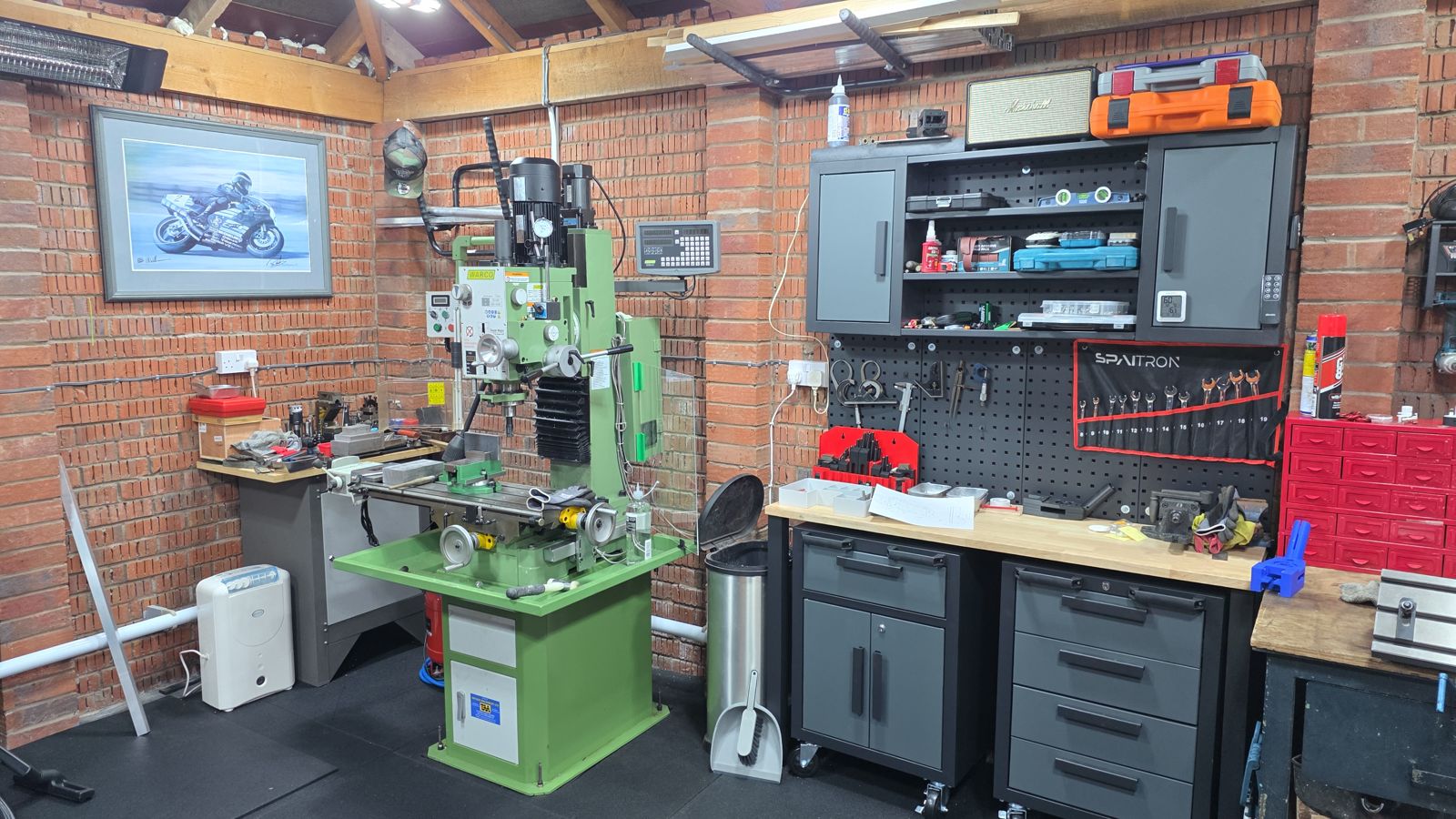 Garage workshop with a milling machine fitted with a digital readout, workbenches and tool storage